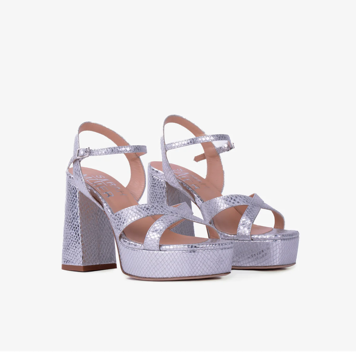Silver platform sandals worn with black lace