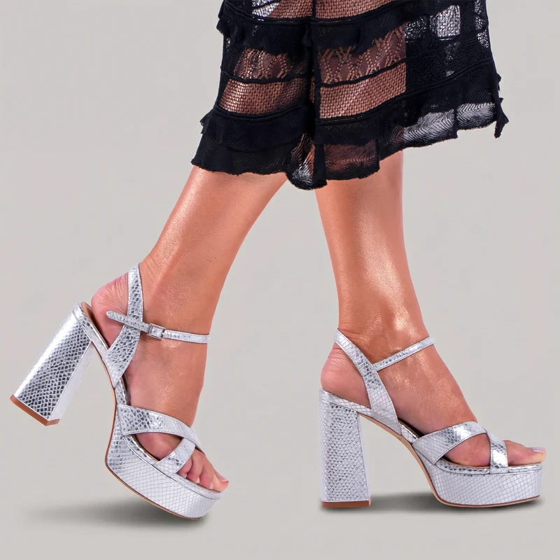 Silver sandal worn with black lace